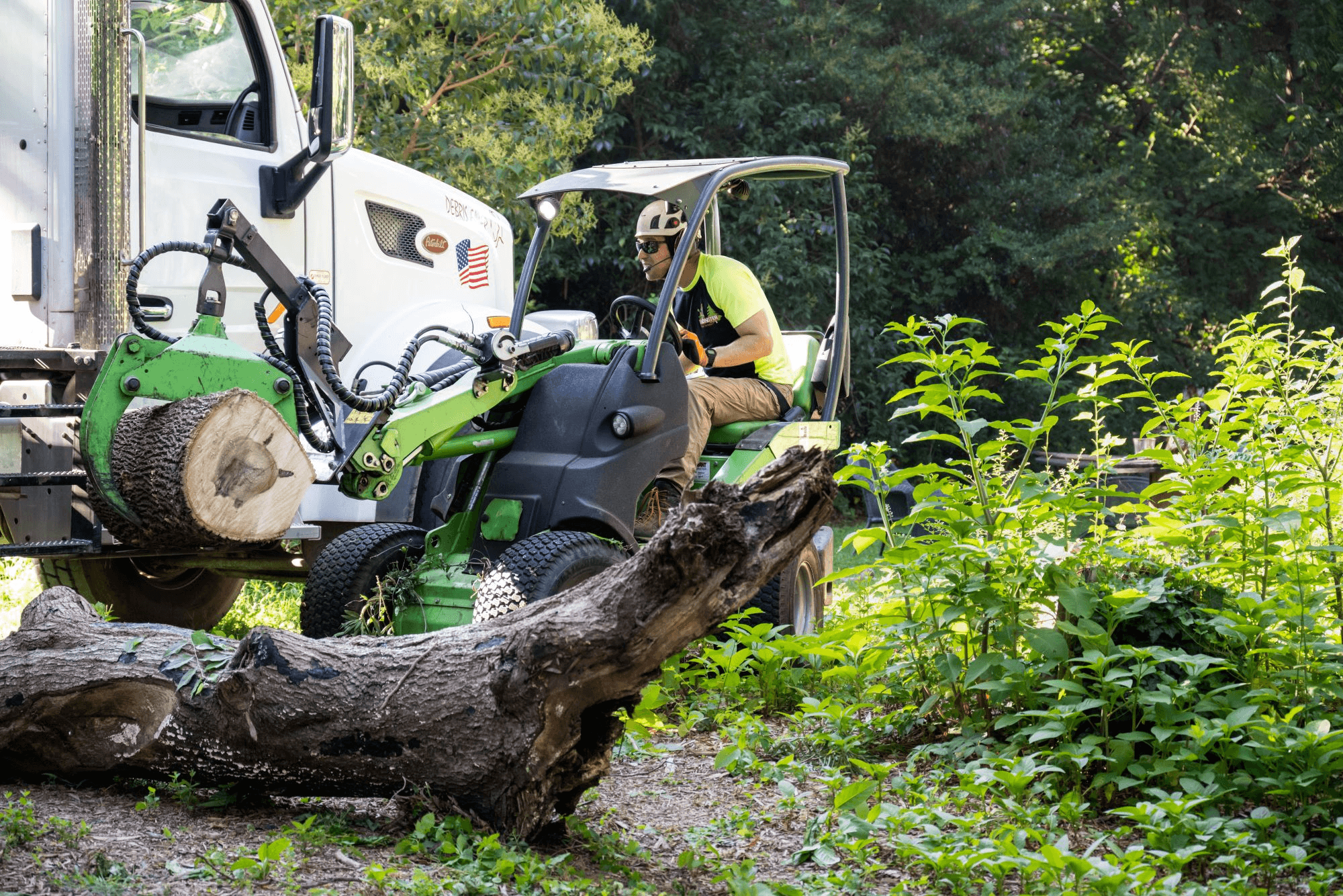 A tree care professional operating equipment on site